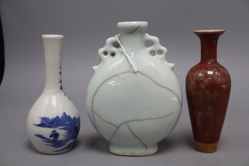 A Chinese moonflask, a blue and white vase and a sang de boeuf vase, tallest 17cm